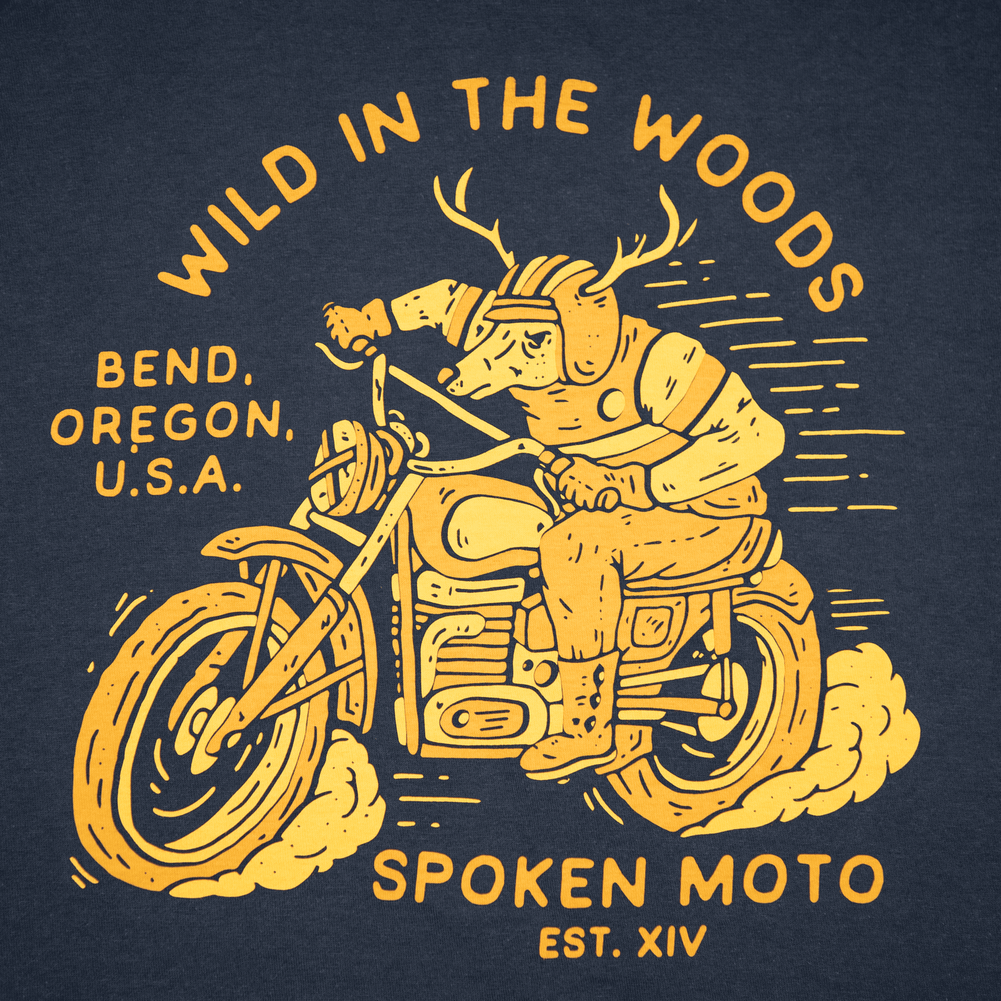 Close-up shot of the yellow/gold Spoken Moto deer riding a motorcycle logo.