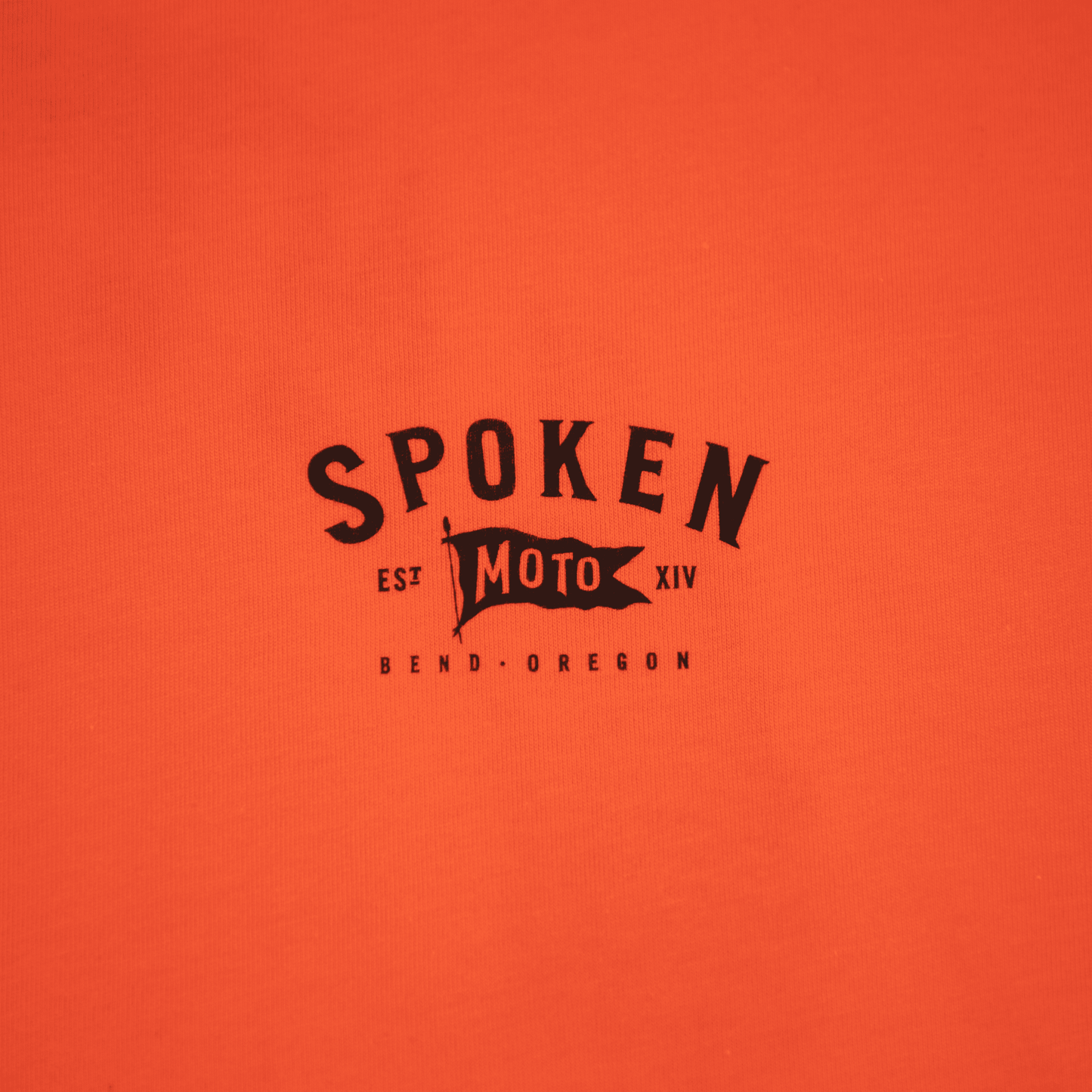 Detail shot of the upper left chest Spoken Moto logo.