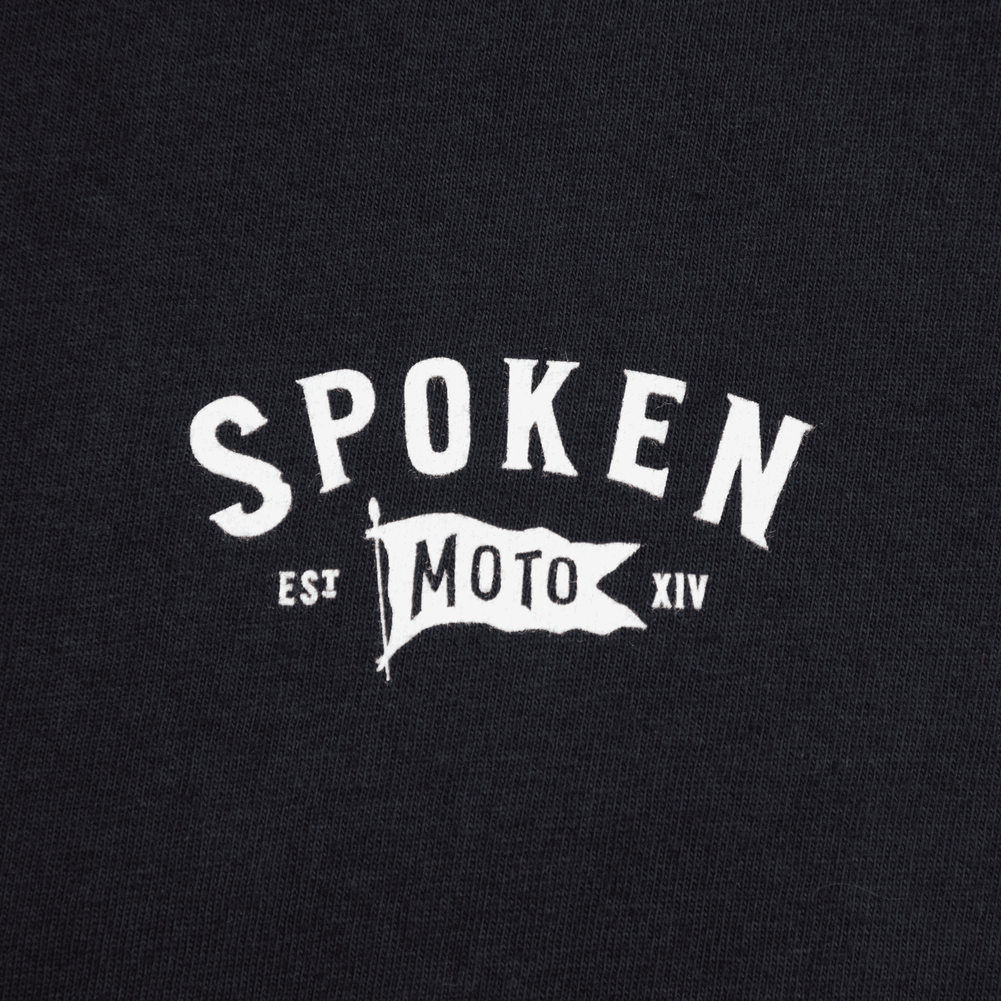 Detail shot of the white Spoken Moto Flag logo.