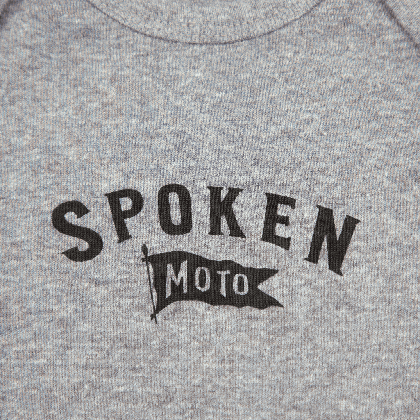 Detail shot of the black Spoken Moto Flag logo.