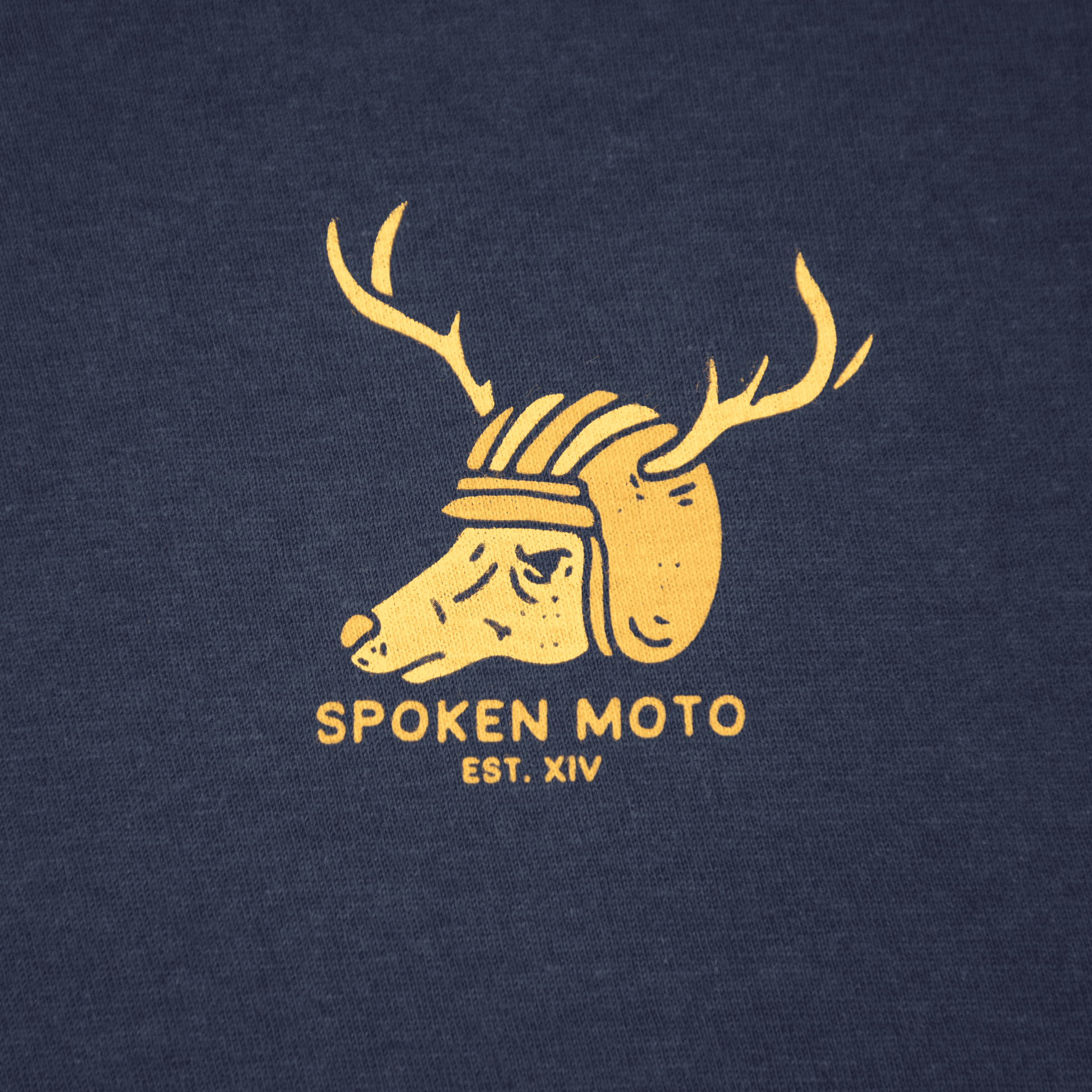 Close-up shot of the yellow/gold Spoken Moto deer logo.