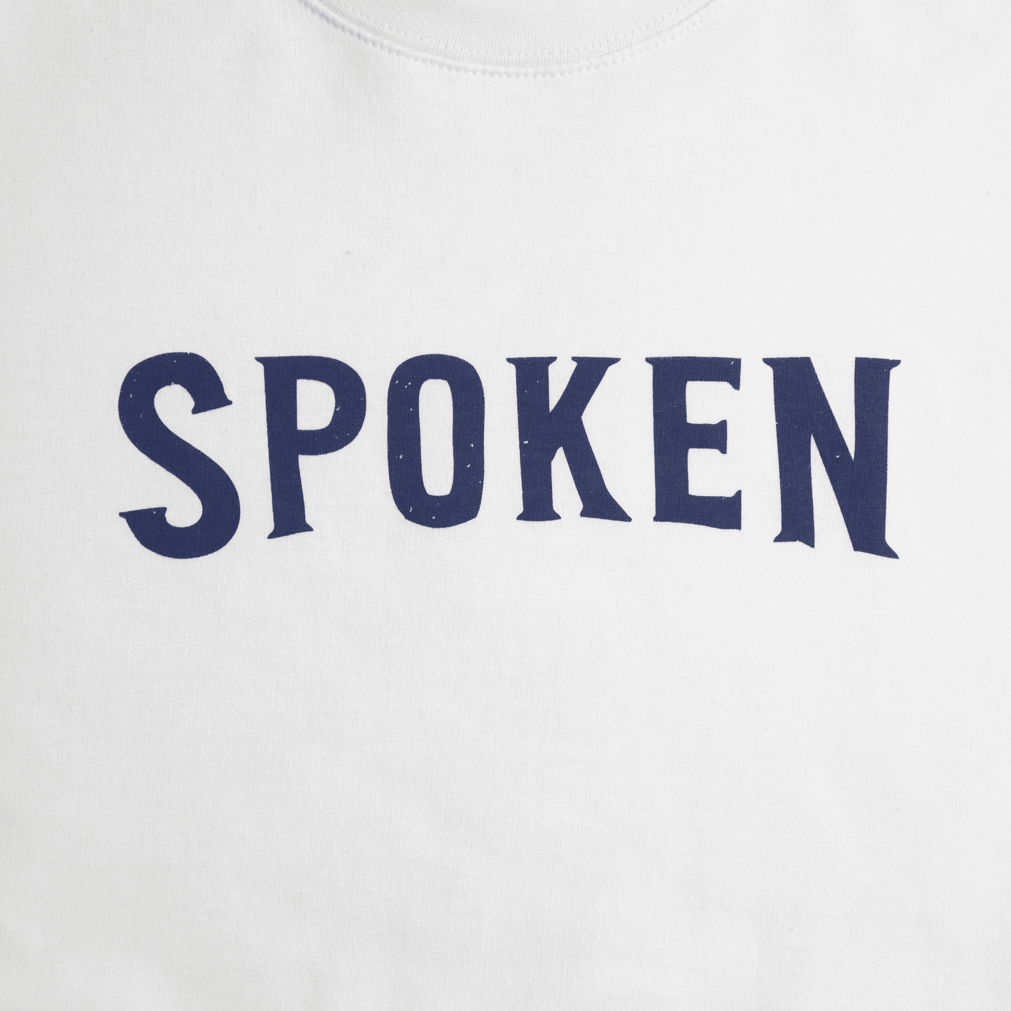 Detail shot of the blue "Spoken" featured on the front of the crewneck.