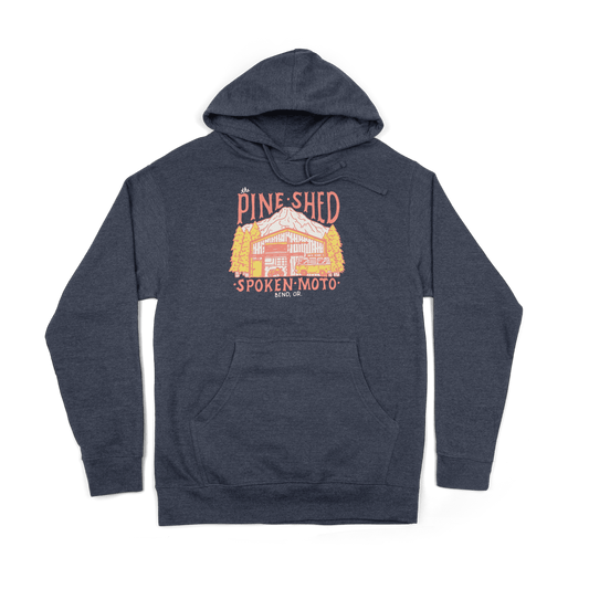 Pine Shed Hoodie from the front: a blue hoodie with colorful pine shed illustration on the center of the chest.